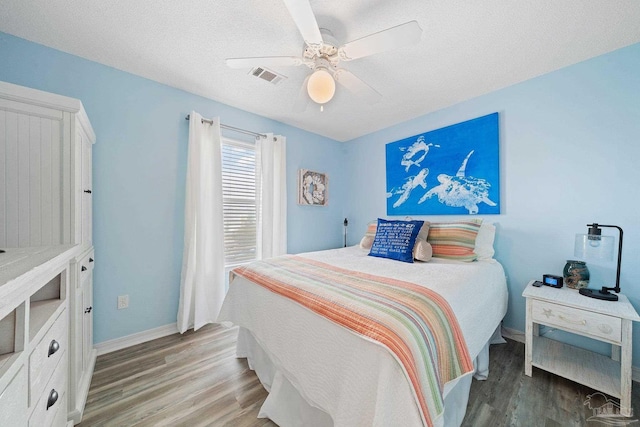 7464 Sunset Harbor Dr Unit 133, Navarre Beach, FL 32566 - bedroom with ceiling fan, light hardwood / wood-style flooring, and a textured ceiling