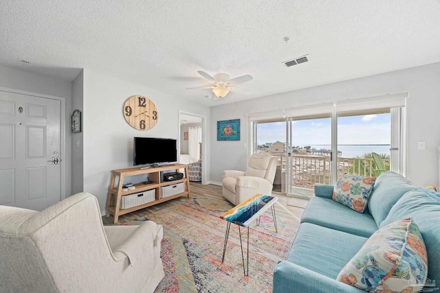7464 Sunset Harbor Dr Unit 133, Navarre Beach, FL 32566 - living room featuring hardwood / wood-style flooring, a textured ceiling, and ceiling fan