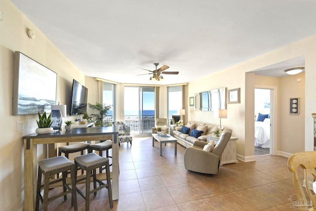 living room featuring expansive windows, a healthy amount of sunlight, and light tile patterned floors