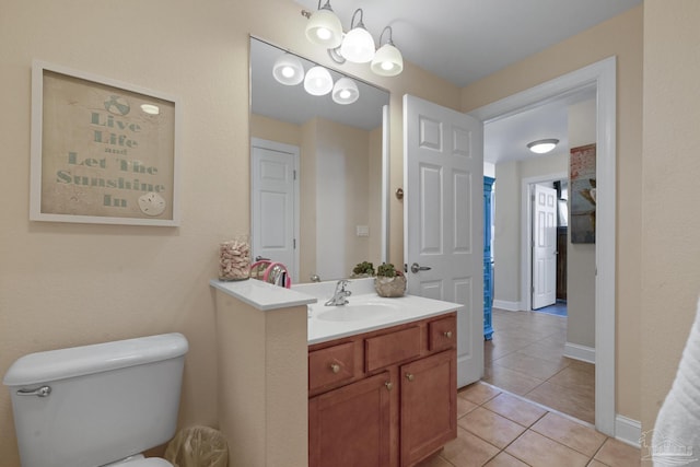 bathroom featuring toilet, tile patterned floors, and vanity