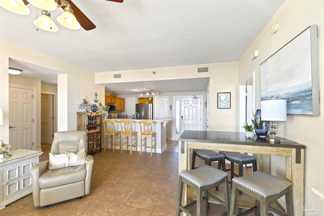 interior space featuring ceiling fan and light tile patterned flooring