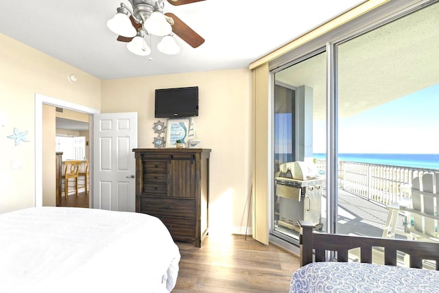 bedroom featuring ceiling fan, hardwood / wood-style floors, and access to outside