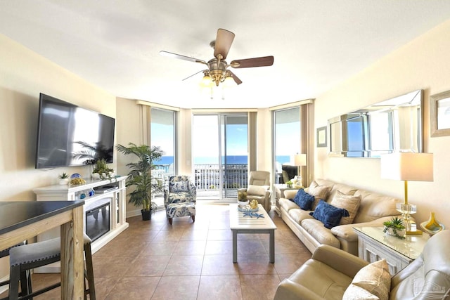 living room featuring a fireplace, tile patterned floors, floor to ceiling windows, and ceiling fan