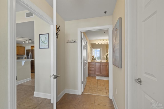 hallway featuring light tile patterned flooring