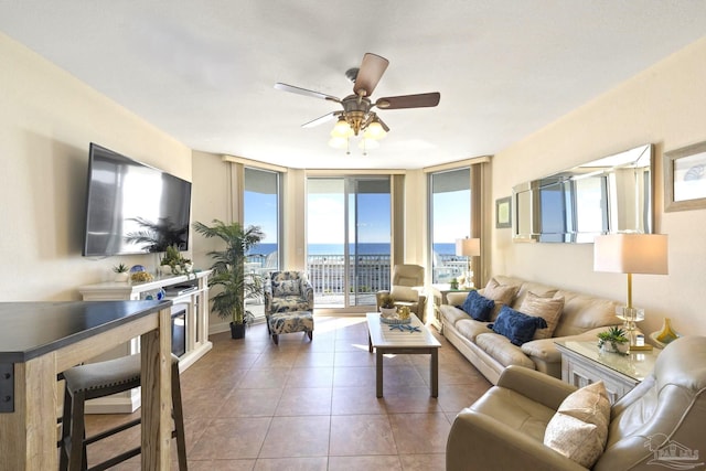 tiled living room featuring floor to ceiling windows and ceiling fan