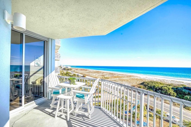 balcony with a view of the beach and a water view