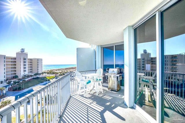 balcony with a grill and a water view