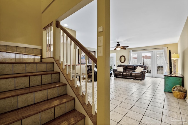 stairs featuring tile patterned floors and ceiling fan