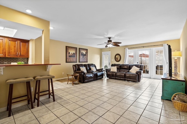 living room with light tile patterned floors and ceiling fan