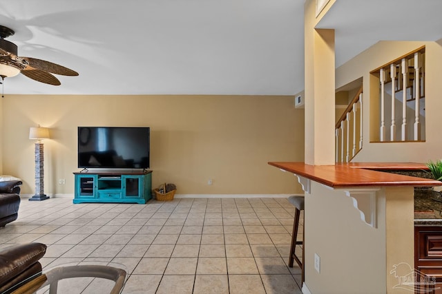 tiled living room featuring ceiling fan