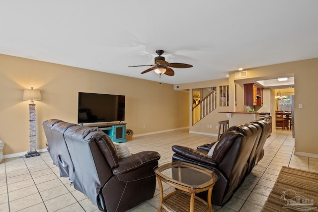 living room featuring ceiling fan with notable chandelier and light tile patterned flooring