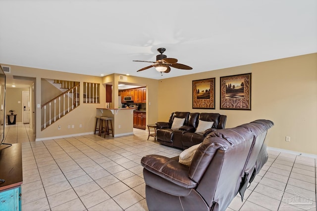 tiled living room featuring ceiling fan