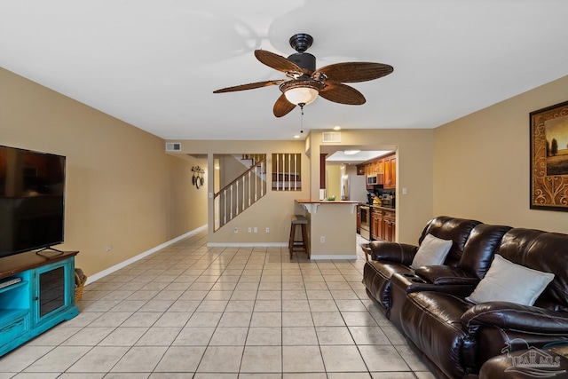 living room featuring ceiling fan and light tile patterned floors