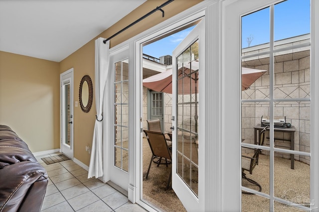 doorway to outside with light tile patterned floors and french doors