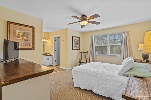 carpeted bedroom featuring ceiling fan and ensuite bathroom