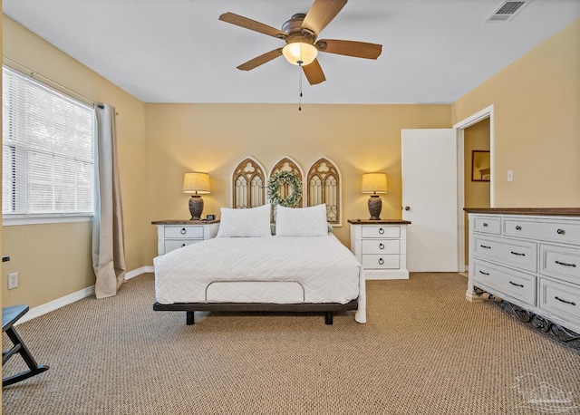 bedroom with ceiling fan and light colored carpet