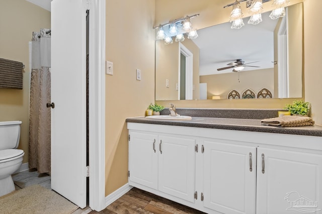 bathroom featuring vanity, ceiling fan, hardwood / wood-style flooring, and toilet