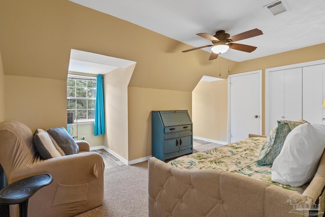 interior space with vaulted ceiling, light colored carpet, and ceiling fan