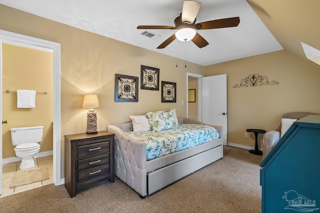 carpeted bedroom featuring connected bathroom, vaulted ceiling, and ceiling fan