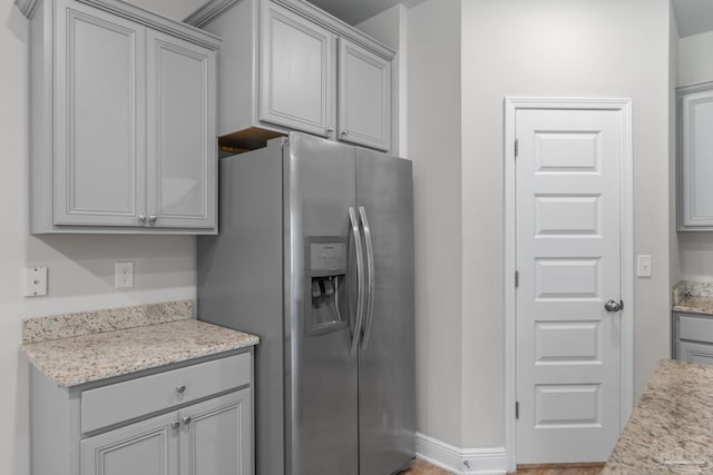 3594 Whitetail Ln, Pensacola, FL 32526 - kitchen featuring stainless steel fridge with ice dispenser, gray cabinetry, and light stone countertops
