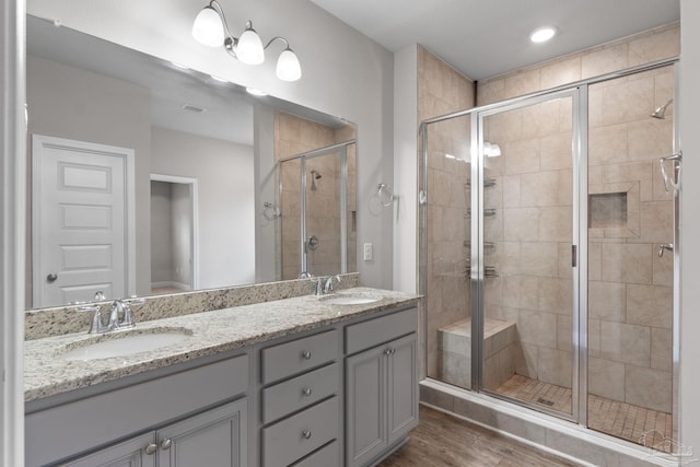 3594 Whitetail Ln, Pensacola, FL 32526 - bathroom featuring a stall shower, double vanity, wood finished floors, and recessed lighting