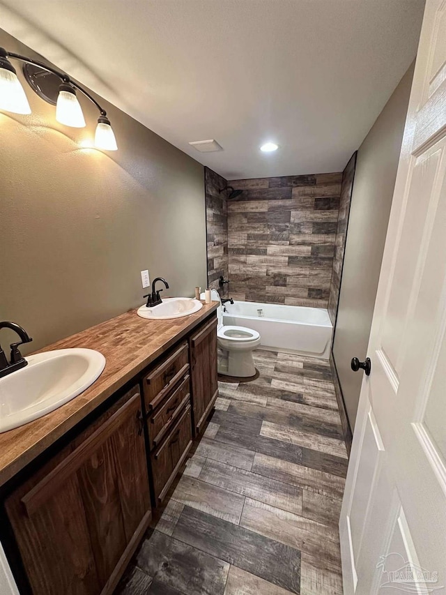 bathroom featuring toilet, vanity, and hardwood / wood-style flooring