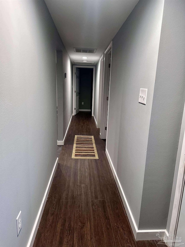 corridor with dark hardwood / wood-style floors