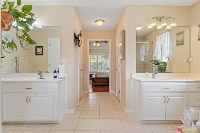 bathroom with ceiling fan, double sink vanity, and tile patterned floors