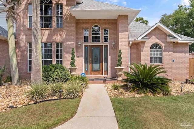 doorway to property featuring a yard