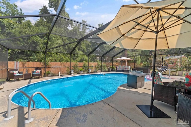 view of swimming pool featuring glass enclosure and a patio