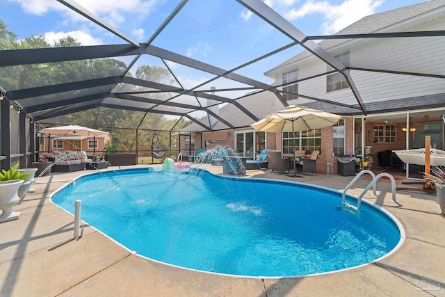 view of pool featuring glass enclosure, a patio, and pool water feature