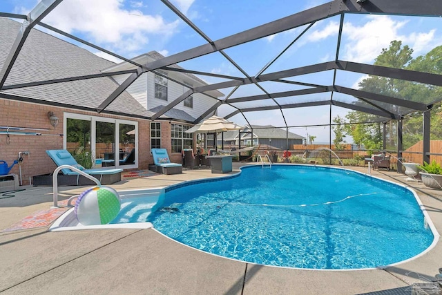 view of pool featuring glass enclosure and a patio area