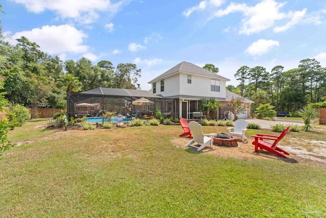 view of yard featuring glass enclosure and a fire pit