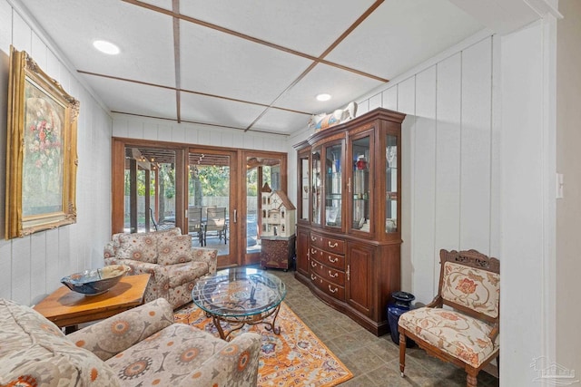 living room with wooden walls and french doors