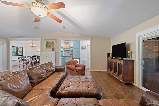 living room featuring ceiling fan with notable chandelier, dark hardwood / wood-style floors, and lofted ceiling