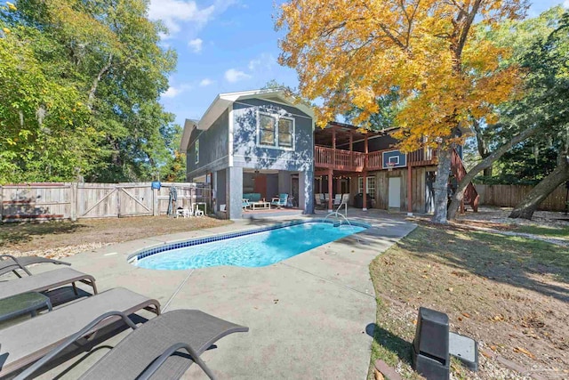 view of swimming pool with a patio and a deck