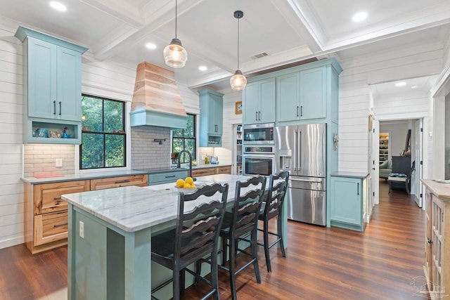 kitchen with beamed ceiling, a center island, stainless steel appliances, and premium range hood