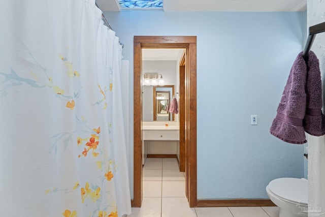 bathroom featuring tile patterned flooring, vanity, and toilet