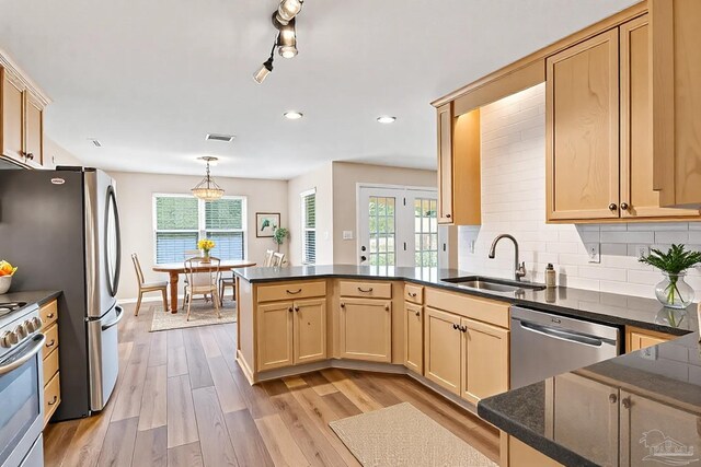 6459 E Quarry Dr, Elberta, AL 36530 - kitchen featuring a sink, stainless steel appliances, a peninsula, dark countertops, and recessed lighting