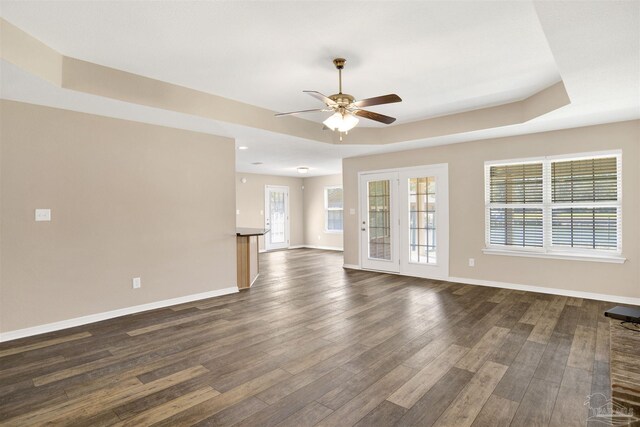 6459 E Quarry Dr, Elberta, AL 36530 - unfurnished living room featuring a raised ceiling, a ceiling fan, dark wood finished floors, and baseboards