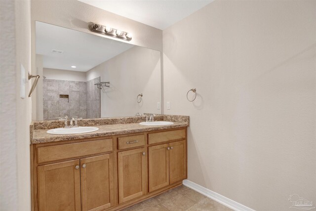 6459 E Quarry Dr, Elberta, AL 36530 - full bathroom with tiled shower, double vanity, baseboards, and tile patterned flooring