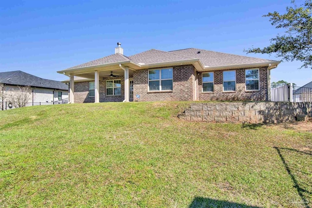6459 E Quarry Dr, Elberta, AL 36530 - back of property featuring a ceiling fan, brick siding, a chimney, and roof with shingles