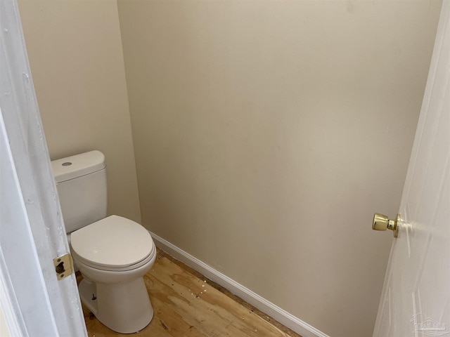 bathroom featuring wood-type flooring and toilet