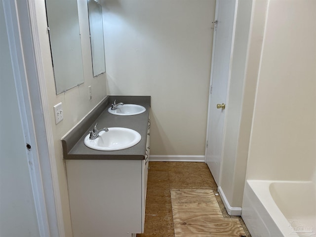 bathroom featuring vanity and a tub to relax in