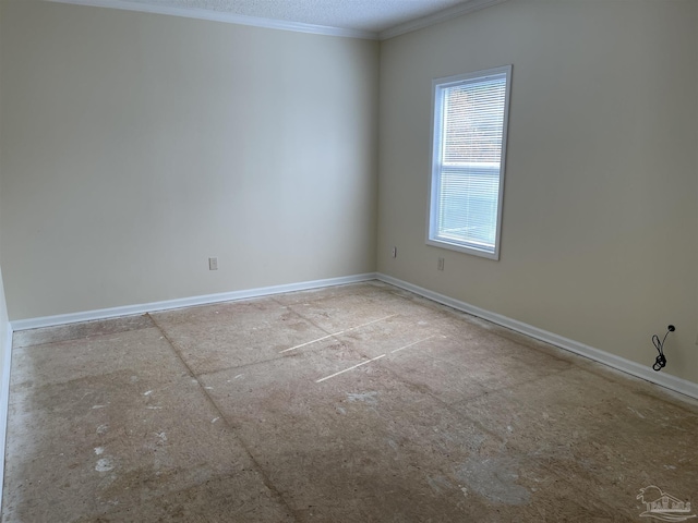 empty room featuring crown molding and a textured ceiling