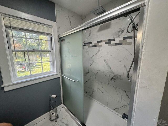 bathroom featuring a wealth of natural light and tile patterned flooring