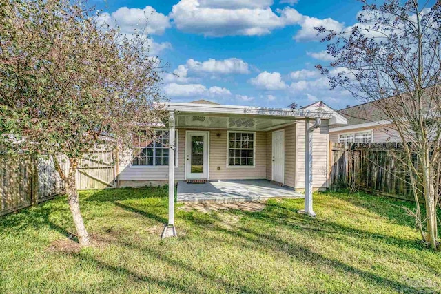 back of house with a patio area, a fenced backyard, and a lawn