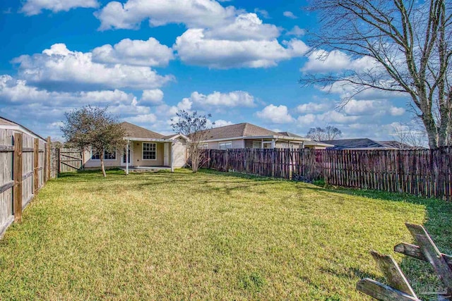 view of yard with a fenced backyard