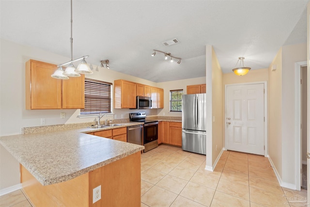 kitchen featuring stainless steel appliances, a peninsula, a sink, visible vents, and light countertops