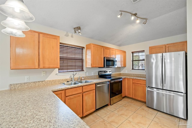 kitchen featuring stainless steel appliances, light countertops, a sink, and light tile patterned flooring